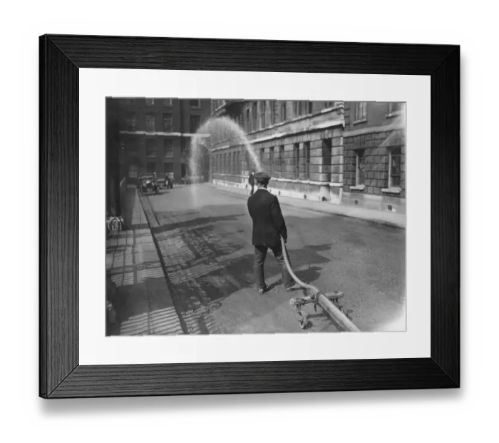 Framed Print : Road Wash. 1925: A roadman spraying down the dust with water in Temple Gardens Framed Print : Road Wash. 1925: A roadman spraying down the dust with water in Temple Gardens