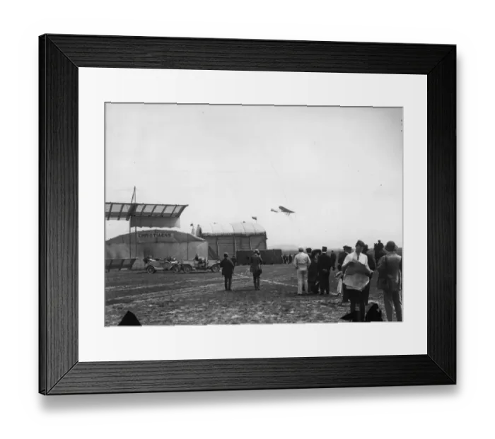 Framed Print : In Flight. July 1910: Planes flying over the hangars at a Bournemouth Aviation meeting Framed Print : In Flight. July 1910: Planes flying over the hangars at a Bournemouth Aviation meeting