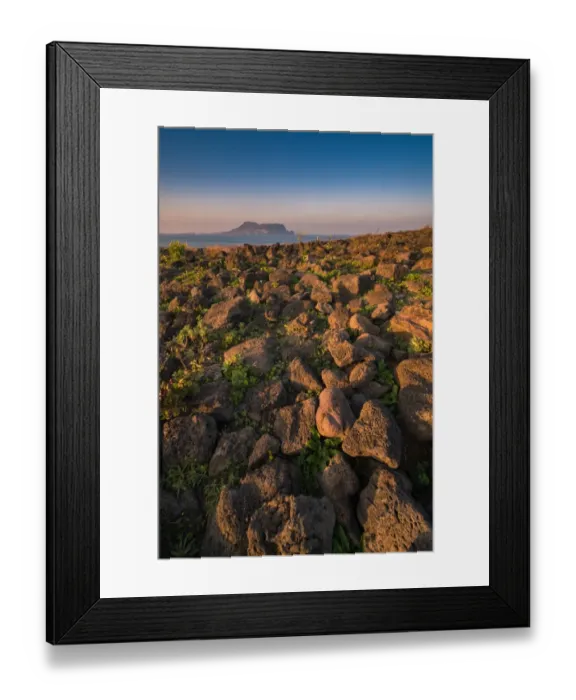 Framed Print : Volcanic rock at Seopjikoji coast with Seongsan background