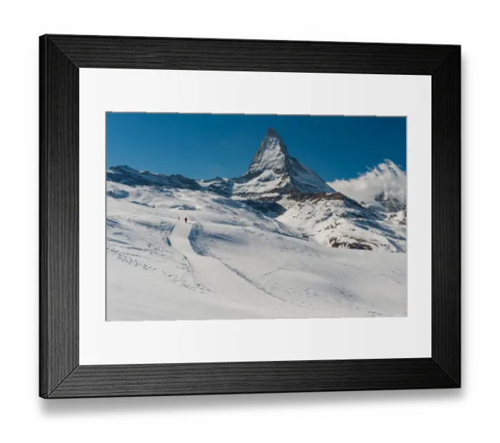 Framed Print : a man walking on a snow trail with Matterhorn background Framed Print : a man walking on a snow trail with Matterhorn background