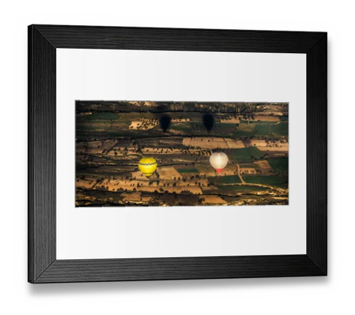 Framed Print : Two balloons floating over Cappadocia landscape Framed Print : Two balloons floating over Cappadocia landscape