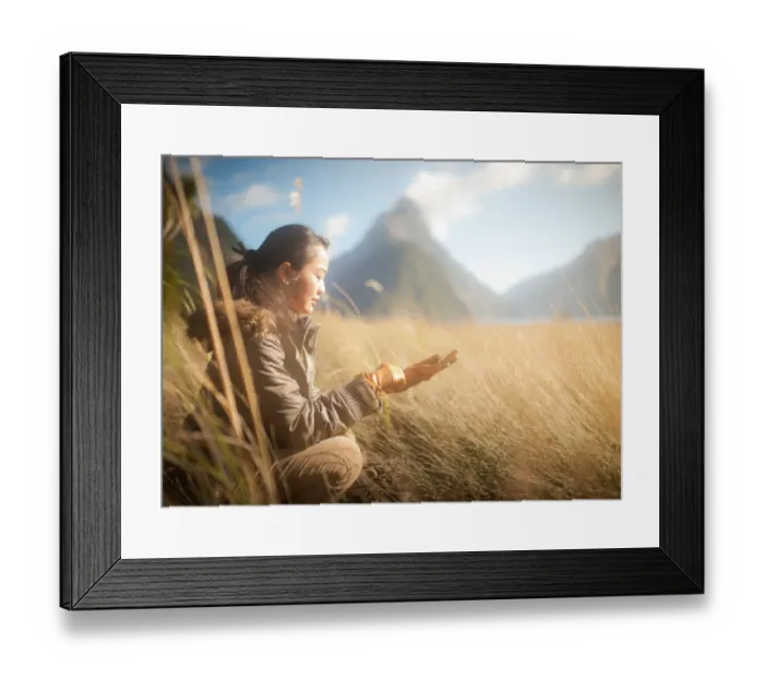 Framed Print : Woman siting in grass field Framed Print : Woman siting in grass field