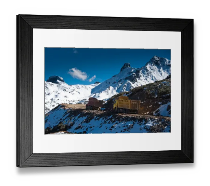 Framed Print : Two trucks drive through snow mountain Framed Print : Two trucks drive through snow mountain