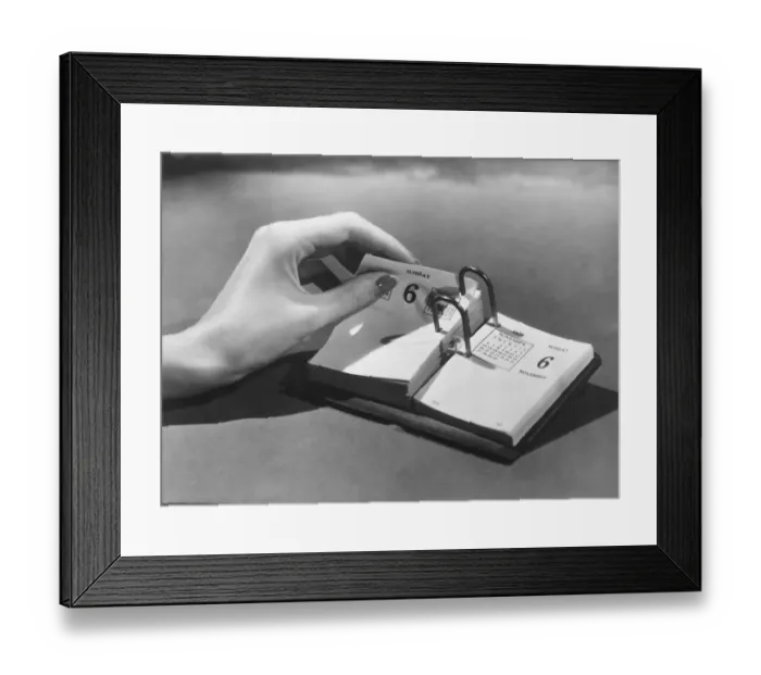 Framed Print : Woman turning page in date book Framed Print : Woman turning page in date book