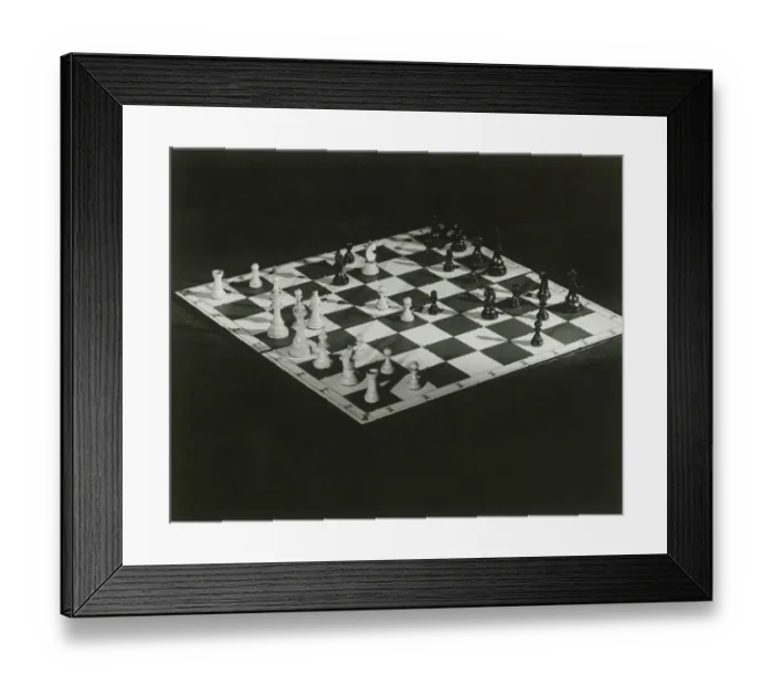 Framed Print : Chess board on black background