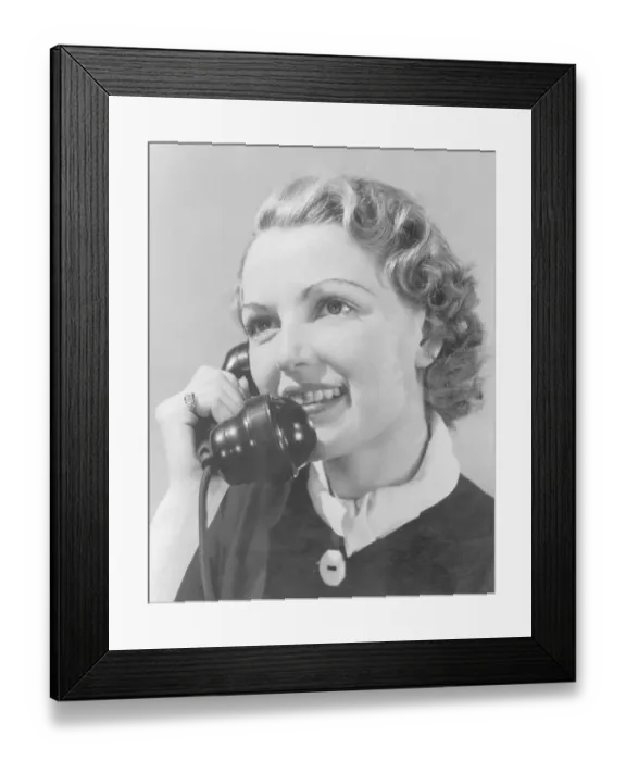 Framed Print : Young woman using telephone, close-up (B&W) Framed Print : Young woman using telephone, close-up (B&W)