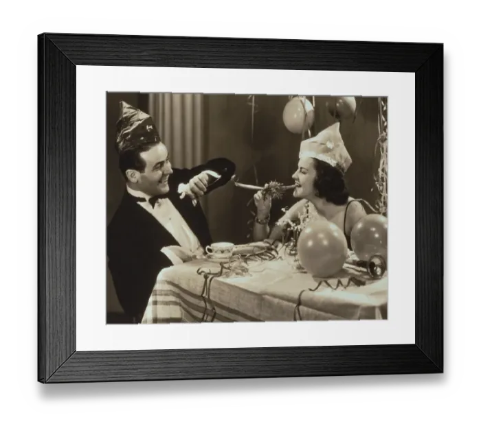 Framed Print : Young couple wearing hats at party, laughing (B&W sepia tone) Framed Print : Young couple wearing hats at party, laughing (B&W sepia tone)