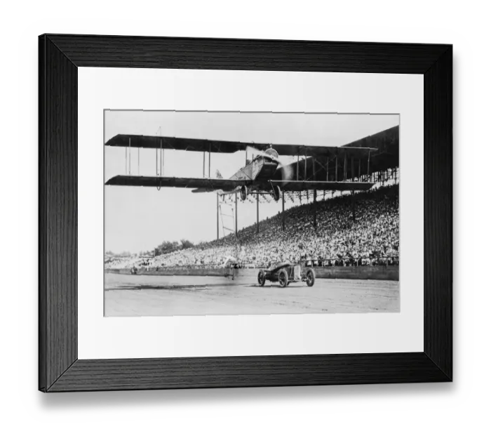 Framed Print : Air Show. A stuntperson leaps from a moving car onto a ladder dangling Framed Print : Air Show. A stuntperson leaps from a moving car onto a ladder dangling