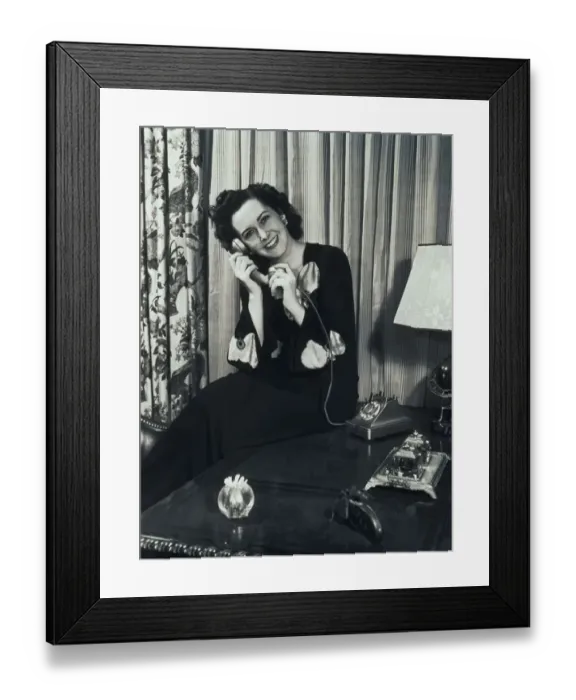 Framed Print : Woman Sitting in Lounge, Talking on Telephone Framed Print : Woman Sitting in Lounge, Talking on Telephone