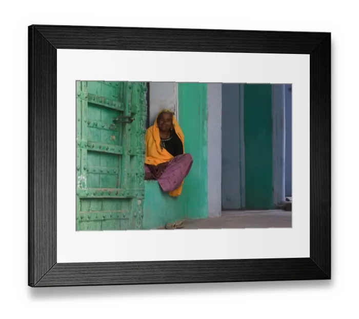 Framed Print : Senior woman sitting in front door of home, smiling, portrait Framed Print : Senior woman sitting in front door of home, smiling, portrait