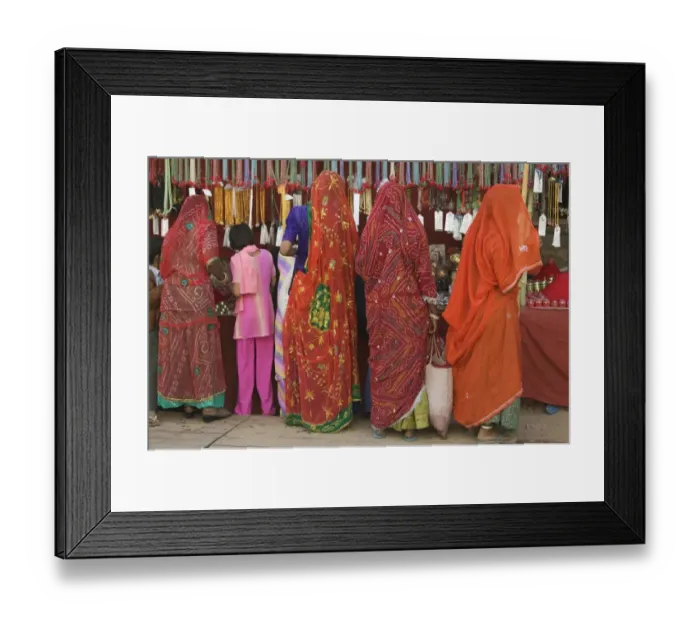 Framed Print : India, Rajasthan, Pushkar, women and girl shopping, rear view Framed Print : India, Rajasthan, Pushkar, women and girl shopping, rear view