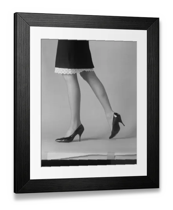 Framed Print : Womans leg with high heels on white background Framed Print : Womans leg with high heels on white background
