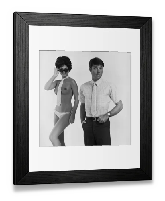 Framed Print : Nude woman wearing tie and sunglasses standing beside man Framed Print : Nude woman wearing tie and sunglasses standing beside man