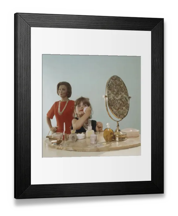 Framed Print : Mother watching daughter applying make-up Framed Print : Mother watching daughter applying make-up