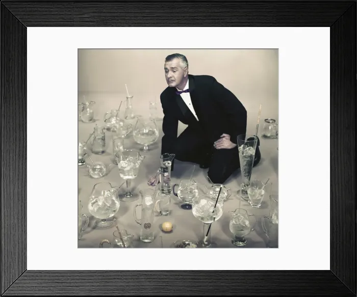Framed Print : Man looking at different types of glasses filled with ice cubes