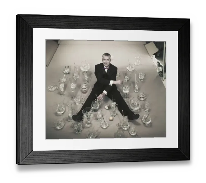 Framed Print : Mature man sitting with stirring glasses of ice Framed Print : Mature man sitting with stirring glasses of ice