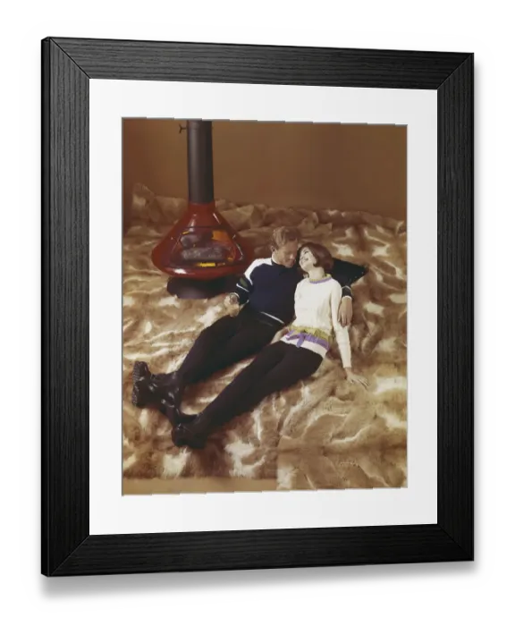 Framed Print : Young couple leaning on fur blanket near fireplace Framed Print : Young couple leaning on fur blanket near fireplace