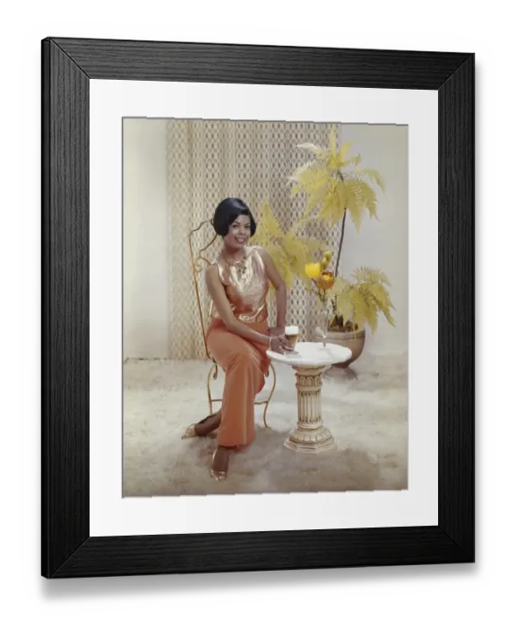 Framed Print : Woman sitting on chair with beer glass, smiling, portrait Framed Print : Woman sitting on chair with beer glass, smiling, portrait
