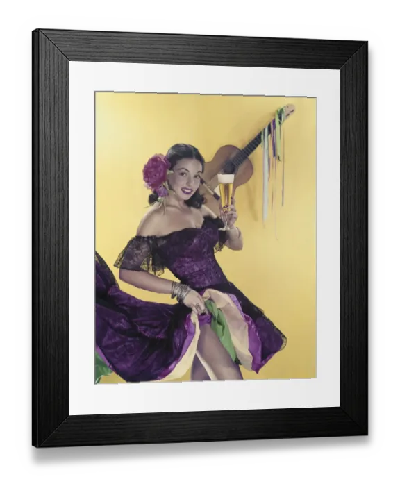 Framed Print : Mid adult woman holding glass of beer with guitar in background Framed Print : Mid adult woman holding glass of beer with guitar in background