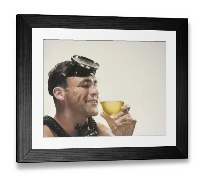 Framed Print : Man wearing snorkel holding wine glass, smiling Framed Print : Man wearing snorkel holding wine glass, smiling