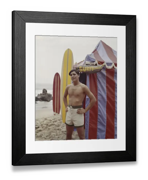 Framed Print : Young man standing beside tent on beach, portrait