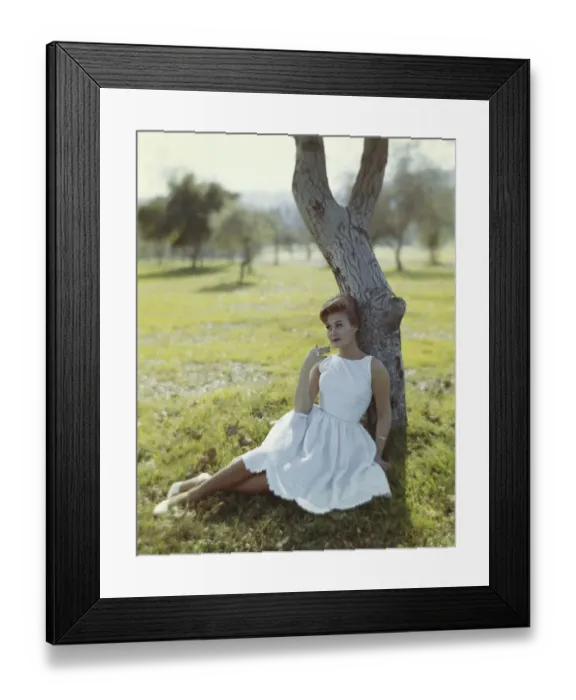 Framed Print : Young woman sitting against tree trunk Framed Print : Young woman sitting against tree trunk