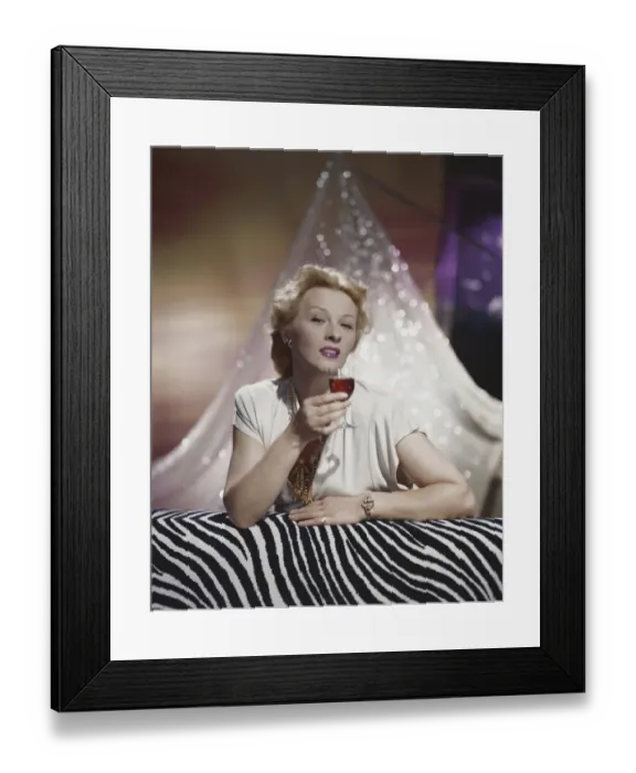 Framed Print : Young woman holding glass of drink, portrait