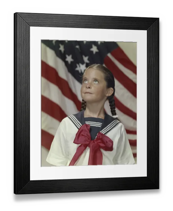 Framed Print : Girl standing and looking up with stars and stripes in background Framed Print : Girl standing and looking up with stars and stripes in background