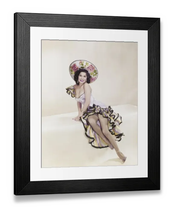 Framed Print : Young woman sitting on pedestal, smiling, portrait Framed Print : Young woman sitting on pedestal, smiling, portrait
