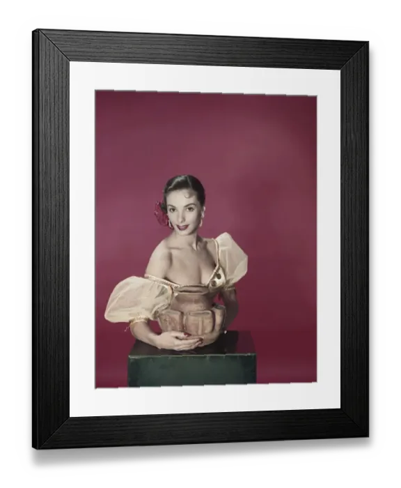 Framed Print : Young woman holding pot, smiling, portrait Framed Print : Young woman holding pot, smiling, portrait