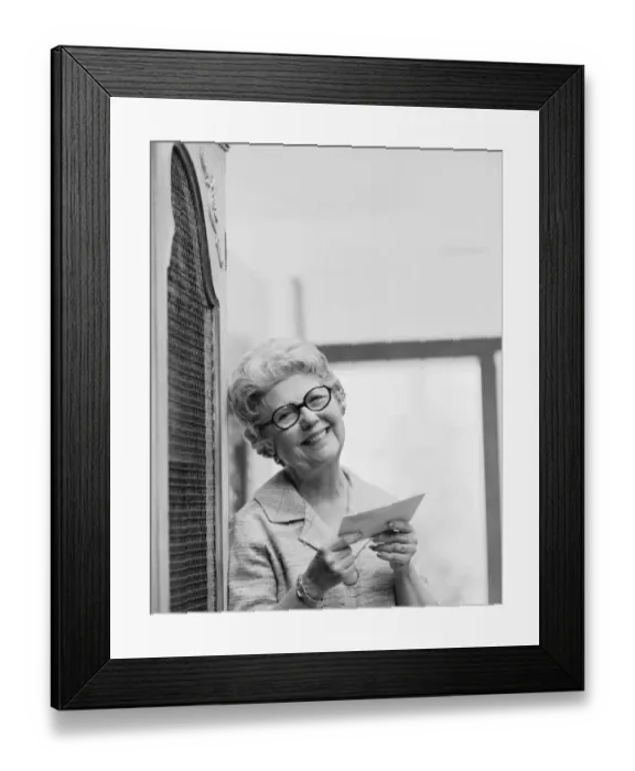 Framed Print : Senior woman holding letter, smiling, portrait Framed Print : Senior woman holding letter, smiling, portrait