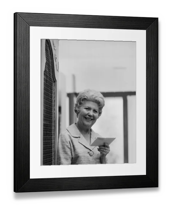 Framed Print : Senior woman holding letter, smiling, portrait Framed Print : Senior woman holding letter, smiling, portrait