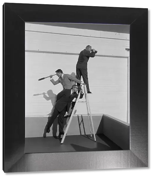 Men standing on ladder with binoculars and telescope