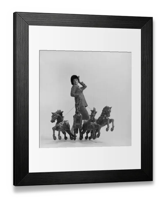Framed Print : Young woman holding rope of toy horses Framed Print : Young woman holding rope of toy horses