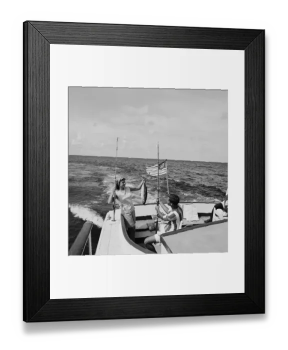 Framed Print : Couple in boat holding fish, smiling Framed Print : Couple in boat holding fish, smiling