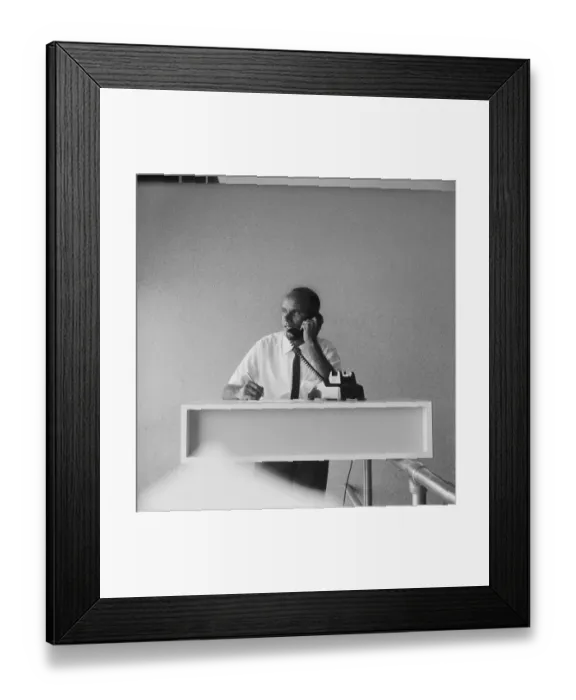 Framed Print : Businessman talking on phone, holding pen Framed Print : Businessman talking on phone, holding pen