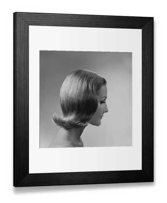 Framed Print : Young woman against white background, close-up Framed Print : Young woman against white background, close-up