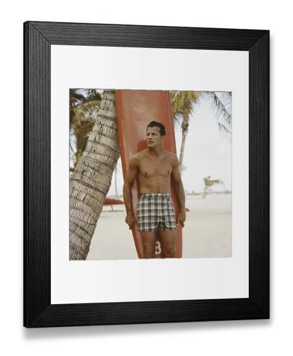 Framed Print : Young man holding surfboard on beach Framed Print : Young man holding surfboard on beach