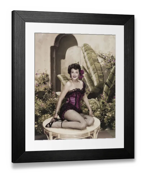 Framed Print : Young woman wearing dress sitting on table, smiling, portrait Framed Print : Young woman wearing dress sitting on table, smiling, portrait