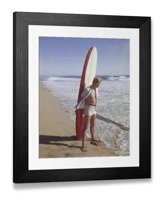 Framed Print : Surfer holding surfboard on beach Framed Print : Surfer holding surfboard on beach