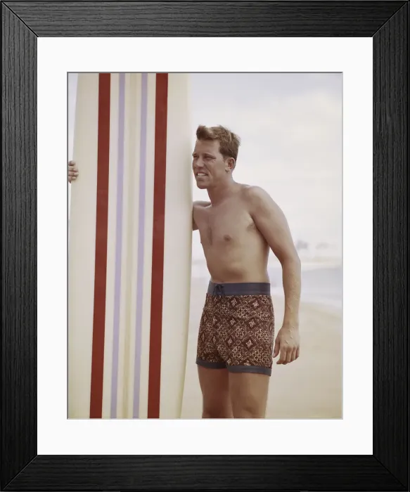 Framed Print : Surfer holding surfboard on beach Framed Print : Surfer holding surfboard on beach