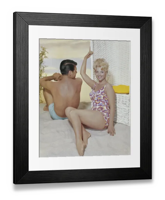 Framed Print : Young woman leaning on swing chair beside man, smiling Framed Print : Young woman leaning on swing chair beside man, smiling