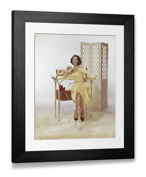Framed Print : Young woman sitting on chair holding beer glass with Screen Partition in background Framed Print : Young woman sitting on chair holding beer glass with Screen Partition in background
