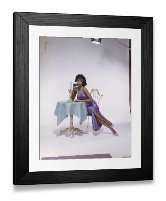 Framed Print : Young woman sitting on chair holding beer glass, portrait Framed Print : Young woman sitting on chair holding beer glass, portrait