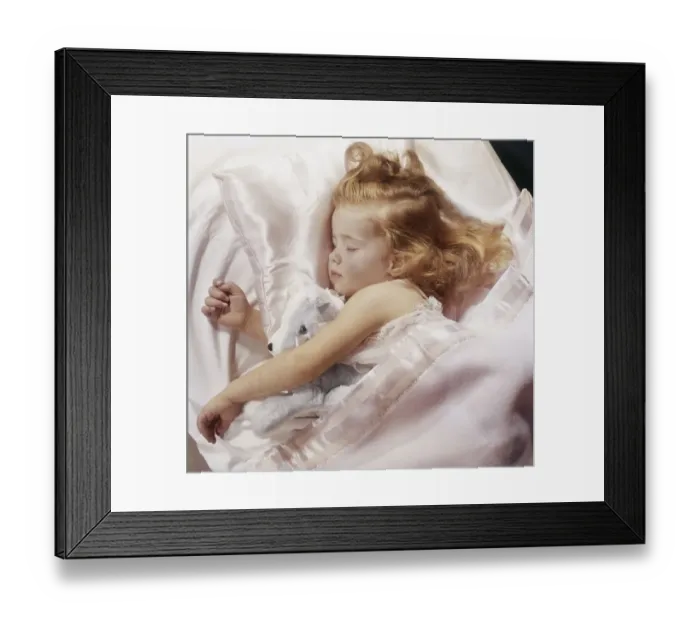 Framed Print : Girl with soft toy sleeping on bed Framed Print : Girl with soft toy sleeping on bed