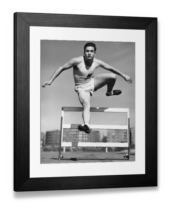 Framed Print : Man jumping hurdle Framed Print : Man jumping hurdle