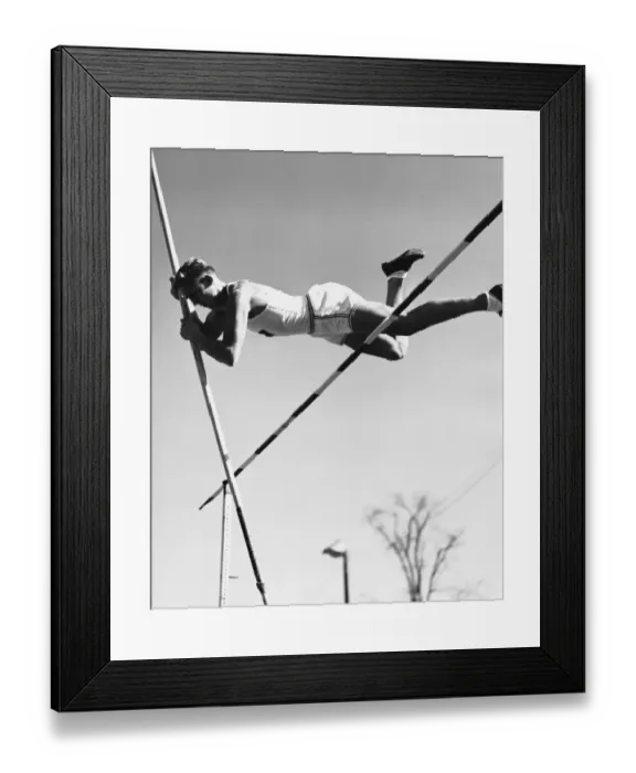 Framed Print : Male pole-vaulter clearing bar Framed Print : Male pole-vaulter clearing bar