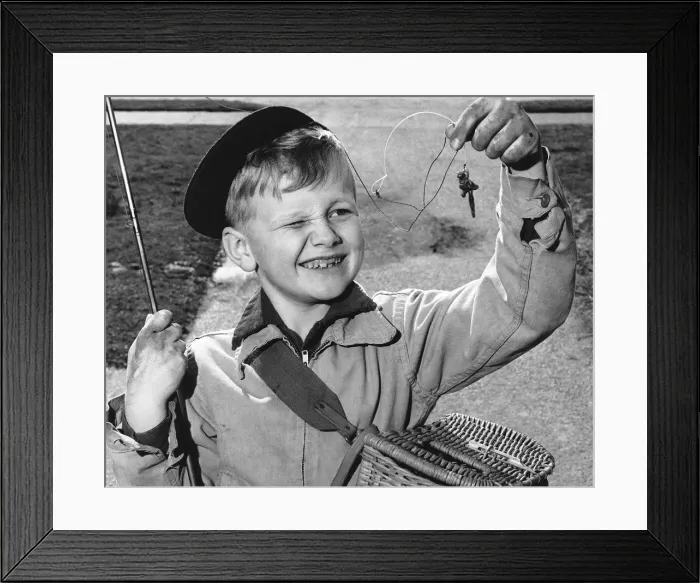 Framed Print : Boy squinting at baited hook Framed Print : Boy squinting at baited hook