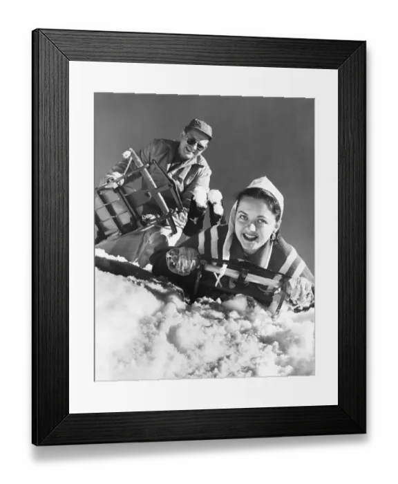 Framed Print : Couple at top of hill, about to go sledding Framed Print : Couple at top of hill, about to go sledding