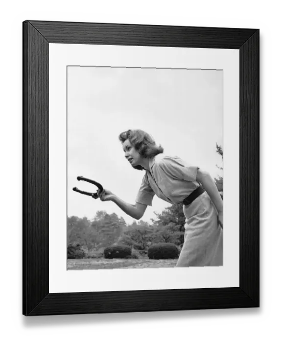 Framed Print : Woman throwing horseshoe Framed Print : Woman throwing horseshoe